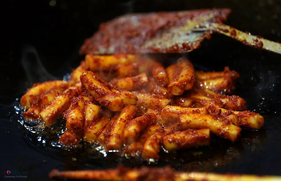 팬에서 볶아지는 붉은 양념 떡볶이